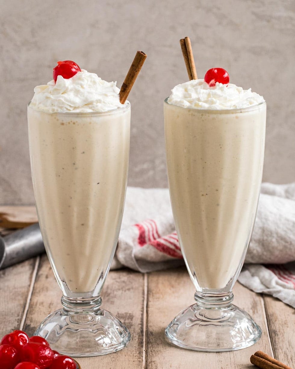 eggnog milkshake in tall glass with cherry