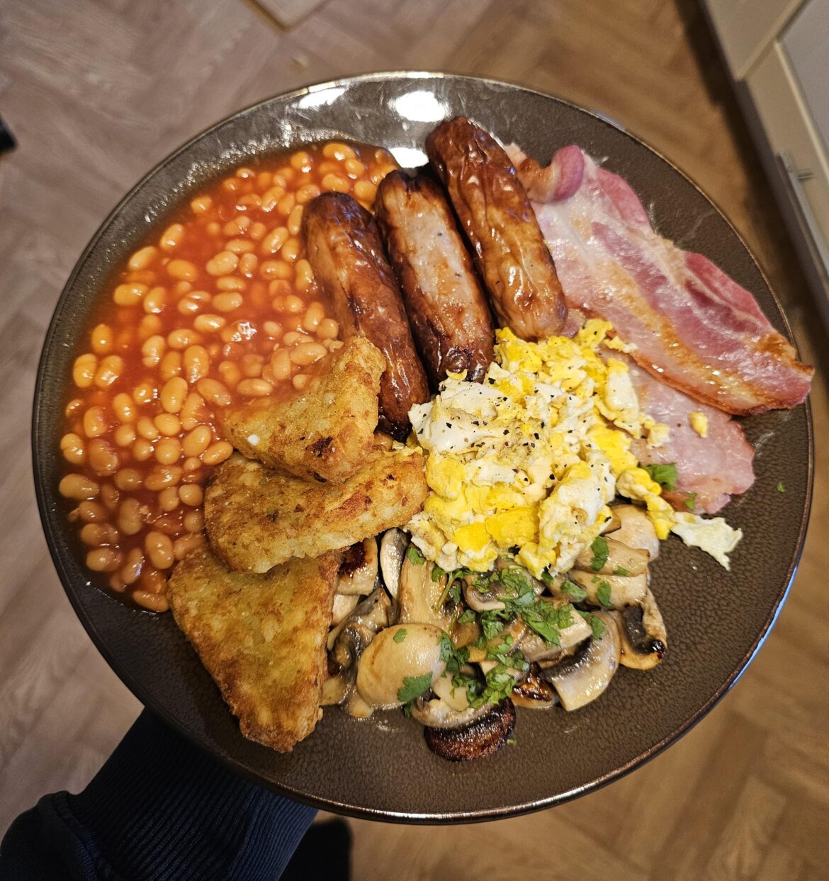 Full English. Garlic mushrooms, scrambled eggs, hash browns, beans, with local butcher's sausages and bacon