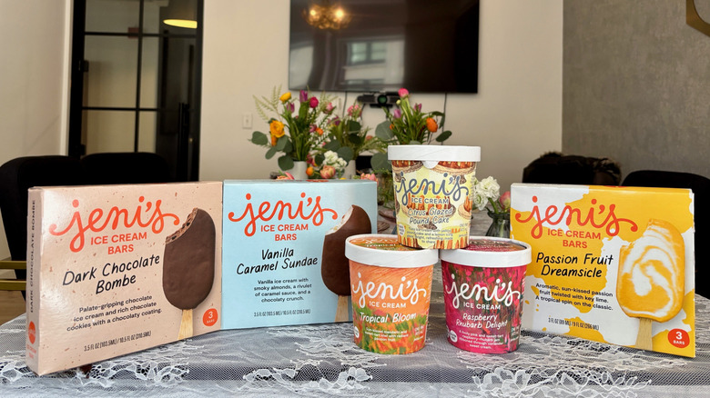 Jeni's three Spring Collection flavors of ice cream and boxes of ice cream bars on table with flowers