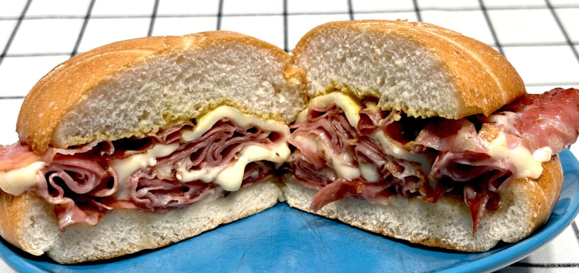 Fried Pistachio Mortadella and Cooper Sharp with Dijon Mustard and a little Mayonnaise on a Kaiser Roll.