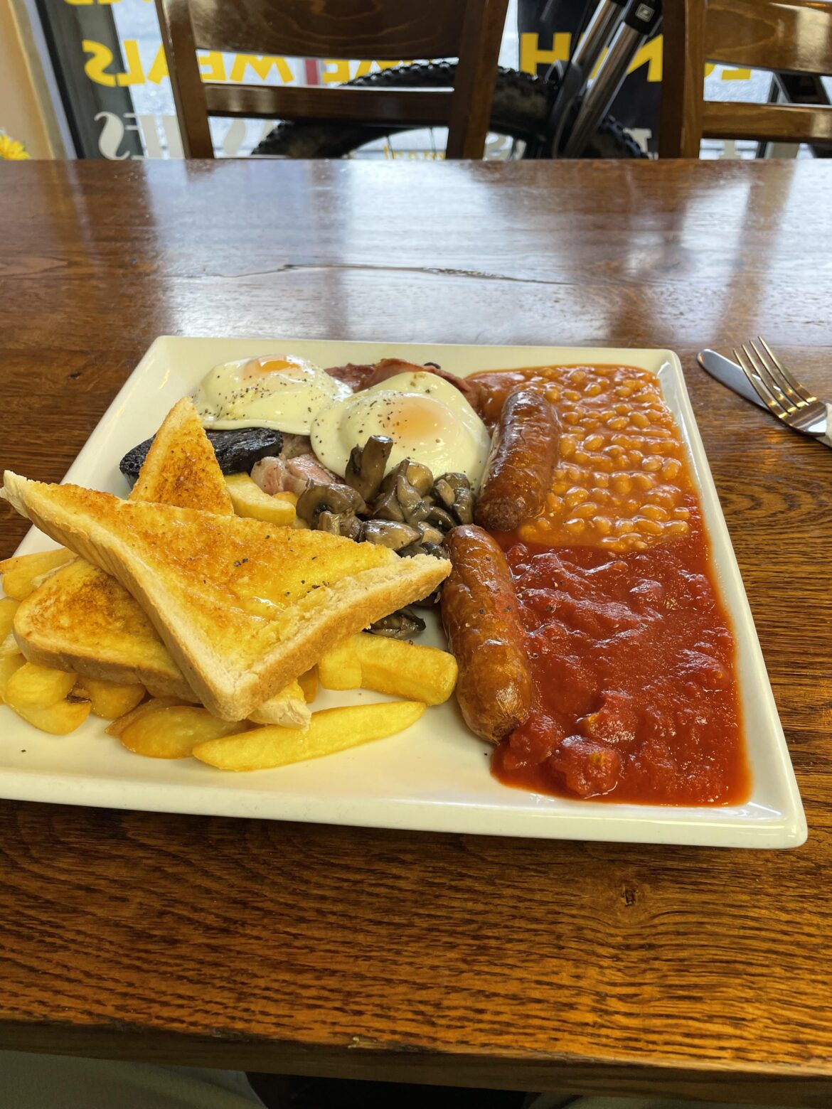 Joe’s Cafe Canton, Cardiff £8. Using the sausages as a barrier to the beans and tomatoes was a nice touch!