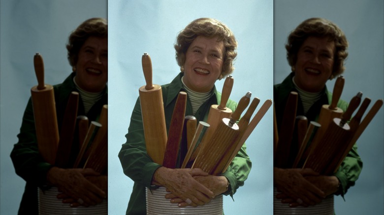 Chef Julia Child posing with rolling pins