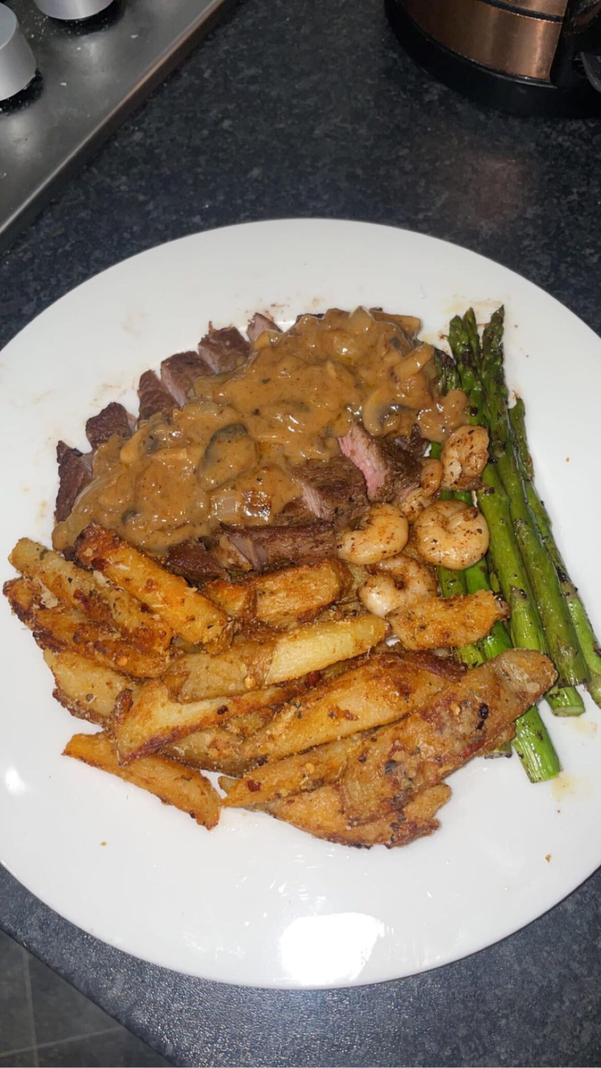 Ribeye x Prawns with Chips and asparagus with mushroom peppercorn sauce. A quick homemade dish on a budget