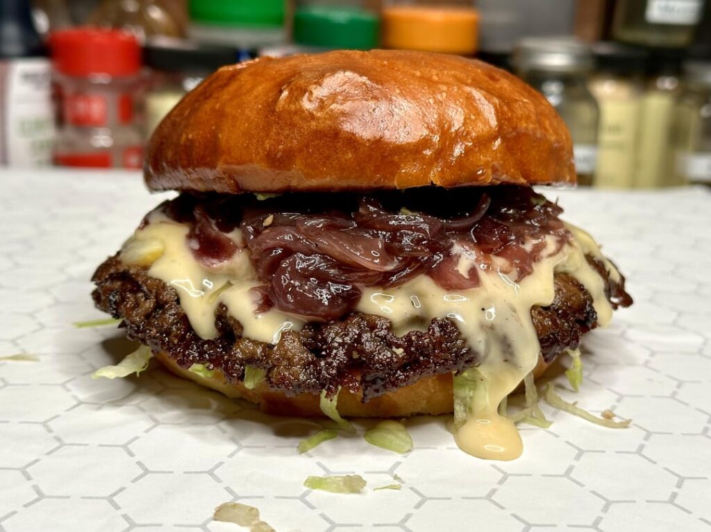 Smash burger with caramelized red onions and avocado