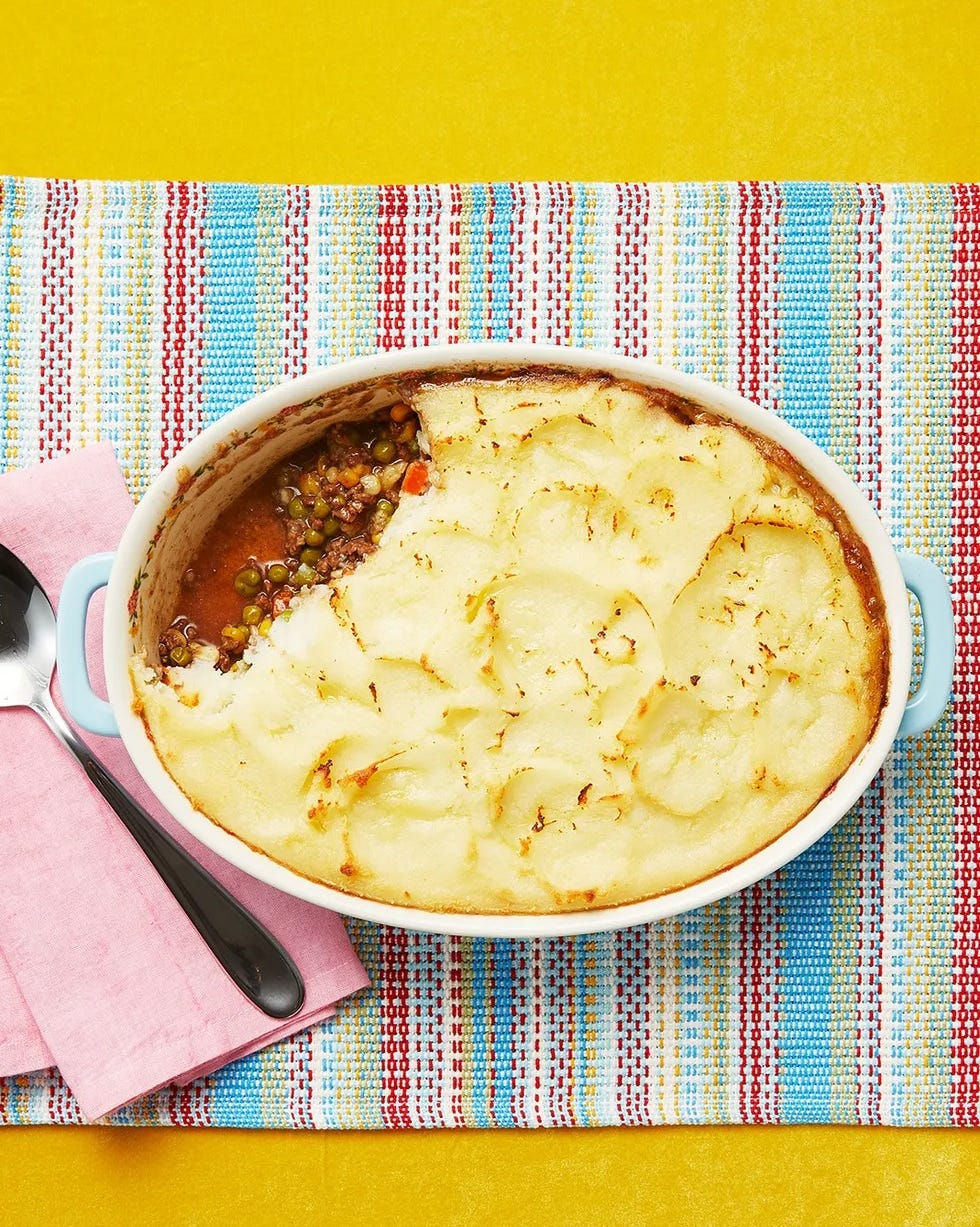 shepherds pie in casserole dish on rainbow background