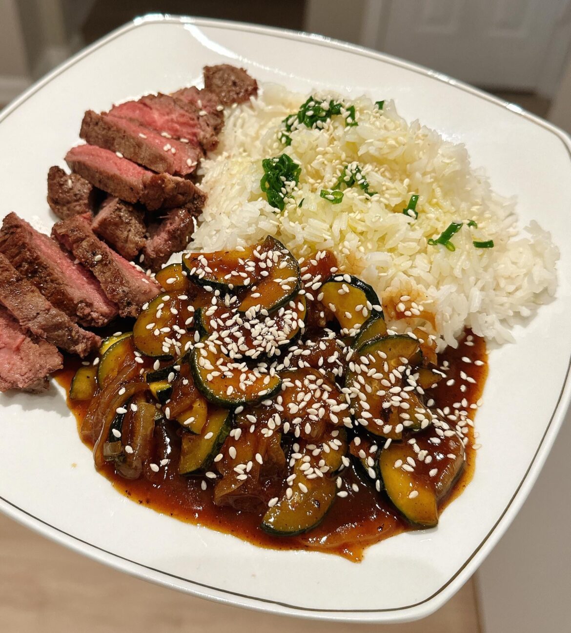 Soy-glazed steak with zucchini stir fry