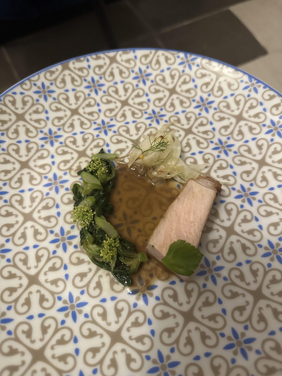 Pork and fennel with sautéed greens