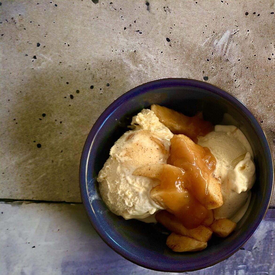 Poached apple with ice cream, and a cinnamon caramel sauce.