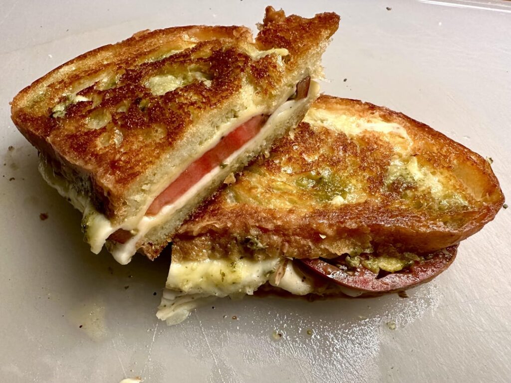 Mozzarella, tomato, and pesto melt on homemade bread