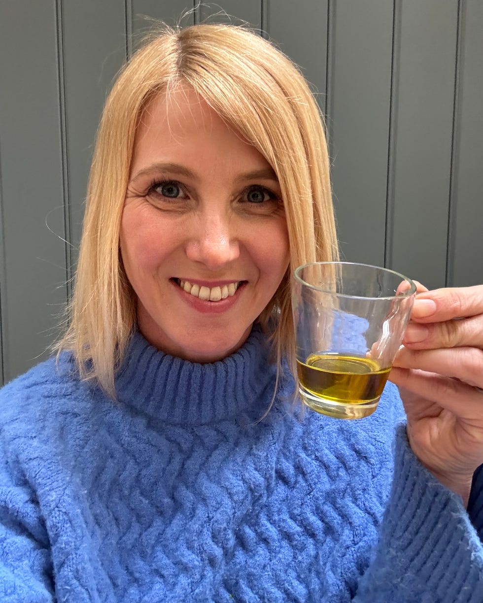 writer drinking a daily shot of extra virgin olive oil as part of the viral tiktok wellness trend