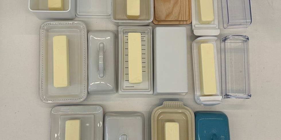 variety of butter containers arranged on a countertop alongside cookie dough