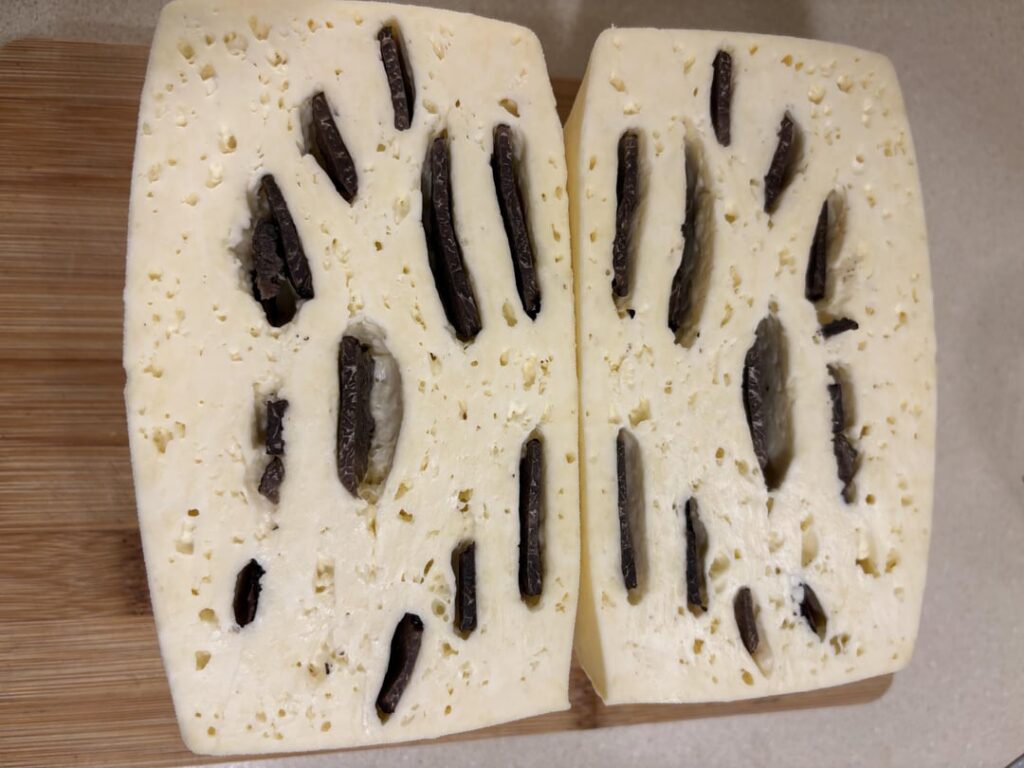Fresh black truffle cheese that was contaminated when making it. It’s called early blow and is usually coliform bacteria. Expensive mishap!