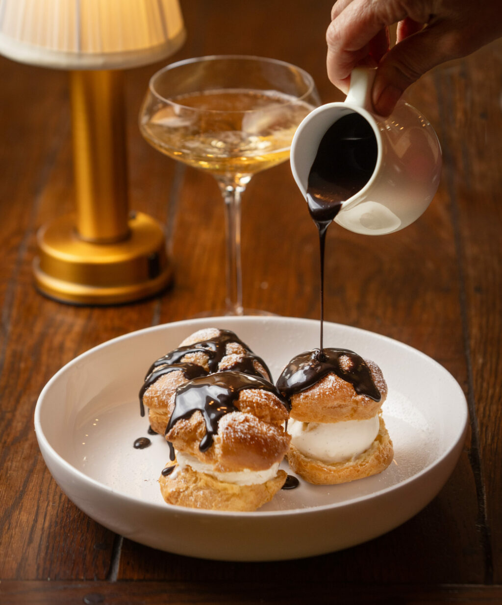 Profiteroles with vanilla ice cream and chocolate sauce from Bistro Jeanty in Yountville, Dec. 19, 2024. (John Burgess / The Press Democrat)