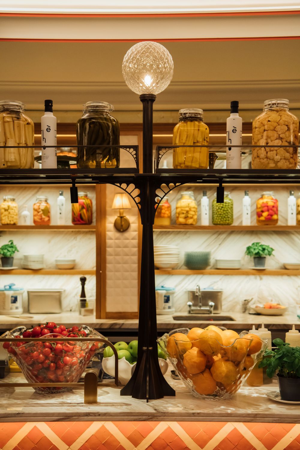 Rose pink bar with glass bowls of fruit and vegetables