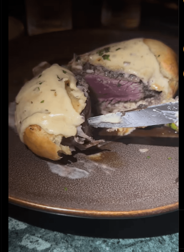 Screenshot of a beef "well"ington form influencer's reel advertising a new trendy place in town. The restaurant was a collaborator on the post.