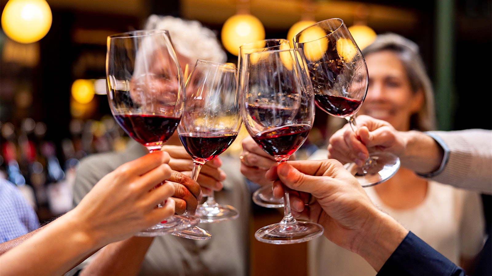  Group of people toasting with glasses of red wine