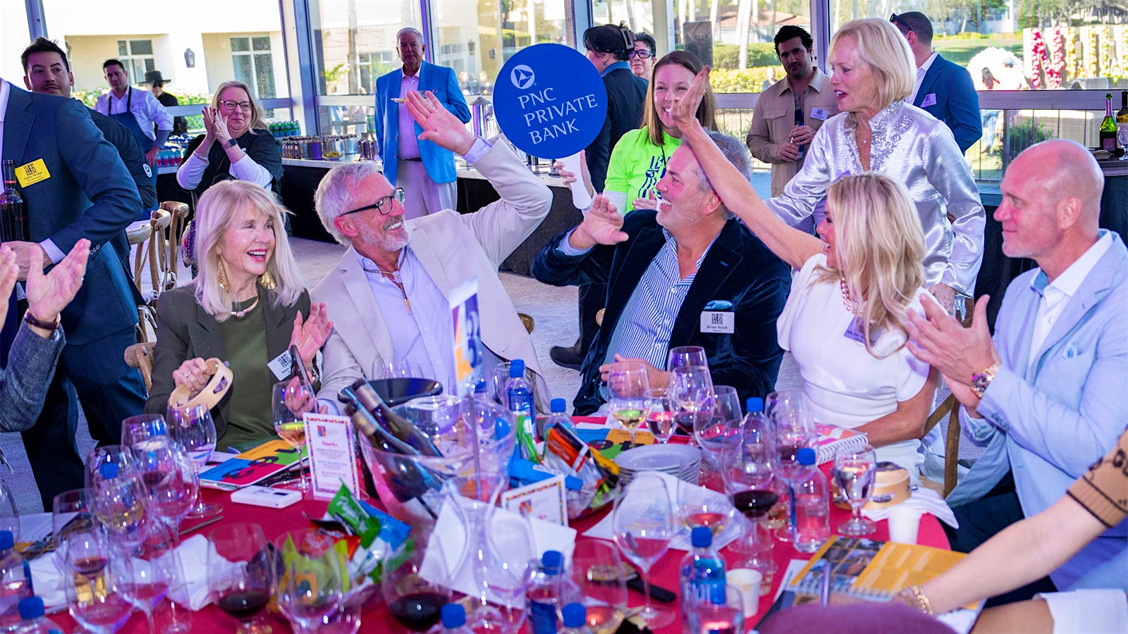  A table of celebrating bidders at the 2025 Naples Winter Wine Festival