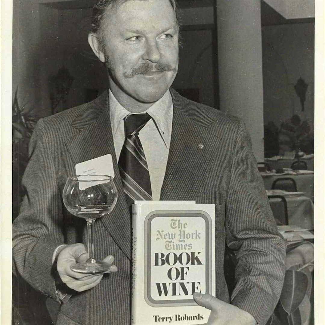  Terry Robards holds a copy of his book, The New York Times Book of Wine.