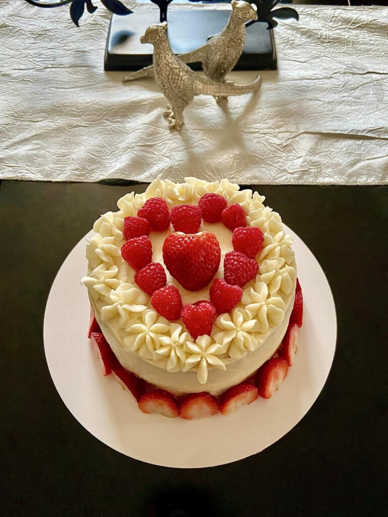 Vanilla cake, vanilla buttercream, filled and topped with strawberries and raspberries 🥰