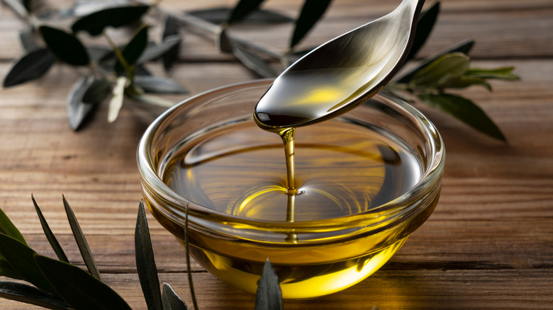 spooning some olive oil