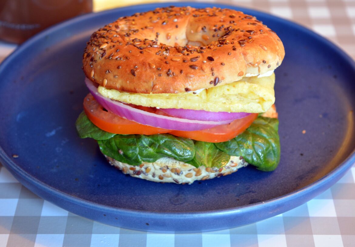 Simple breakfast sandwich (267 cal, 21 g protein). Just Egg, Sola bagel, Laughing cow vegan spread, spinach, tomato, onion