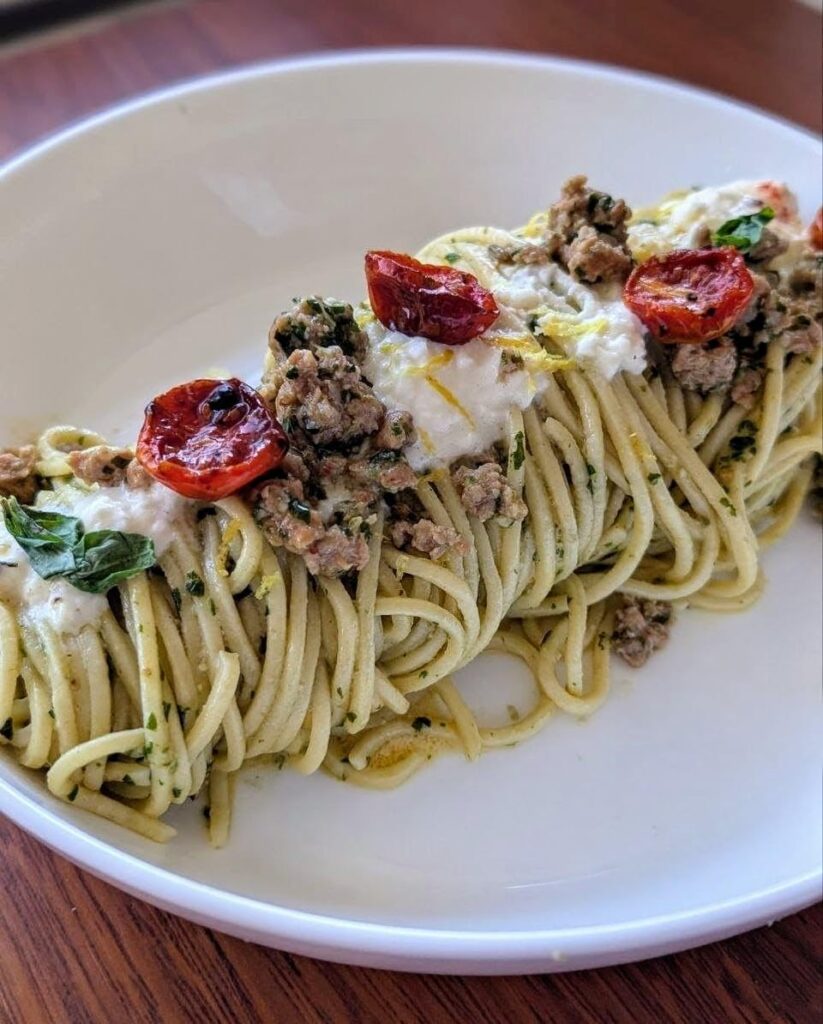Homemade spaghetti alla chitarra, basil pesto, pork sausages, stracciatella and scorza di limone Homemade spaghetti alla chitarra, basil pesto, pork sausages, stracciatella and scorza di limone