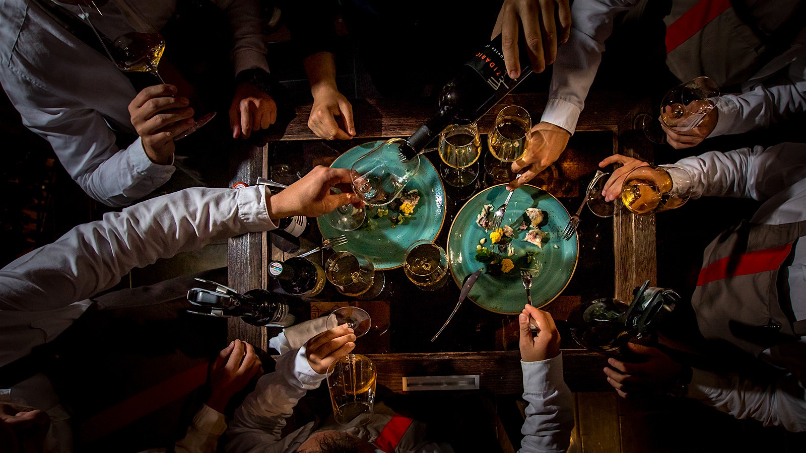  People dining at a table of various dishes, wine glasses and bottles at Restaurant 360 Dubrovnik