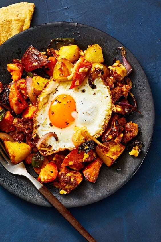 roasted potato and chorizo hash with an egg on top