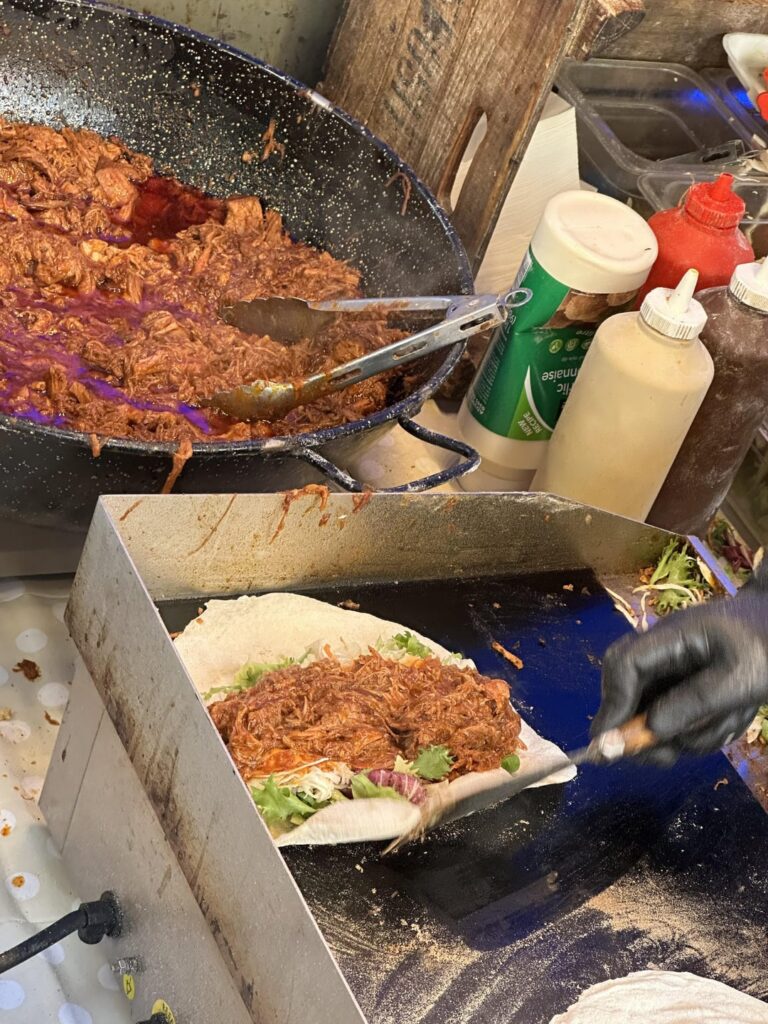 Pulled pork shoulder on lettuce and pickles