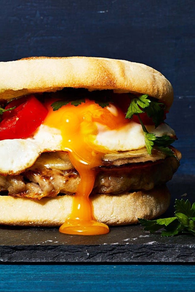 a close up of a sausage and egg sandwich