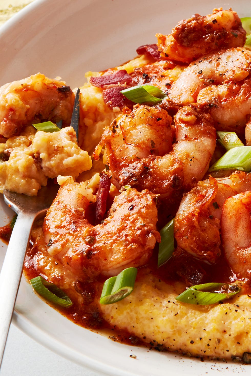 shrimp and grits in a bowl with greens onion