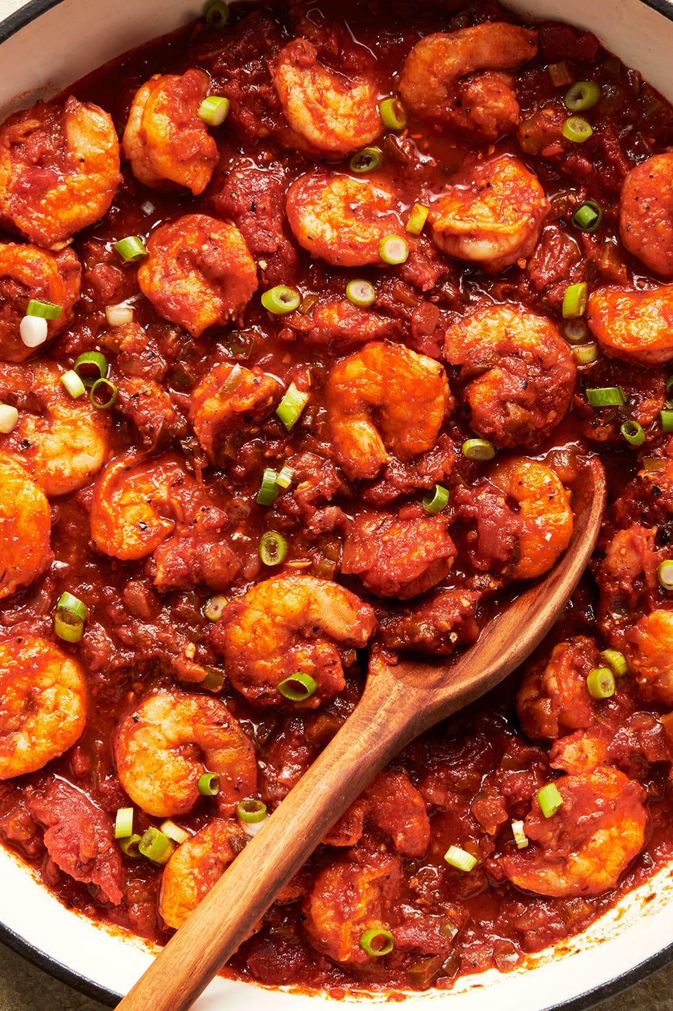 shrimp in a tomato based stew topped with chives and served with rice