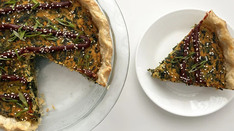 Whole and slice of Korean inspired quiche on a plate