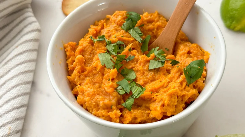 Sweet potato dip garnished with parsley in bowl