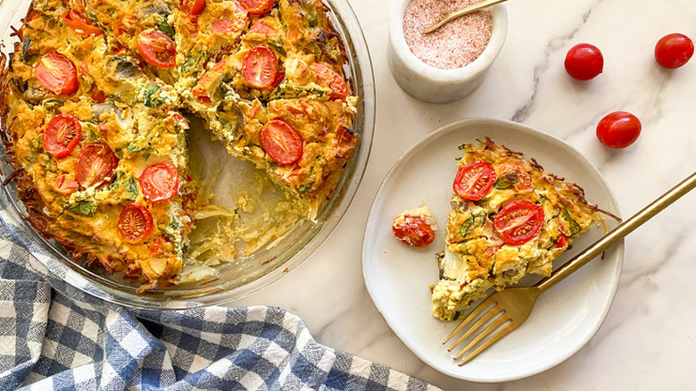 Whole and slice of vegan quiche made with tomatoes
