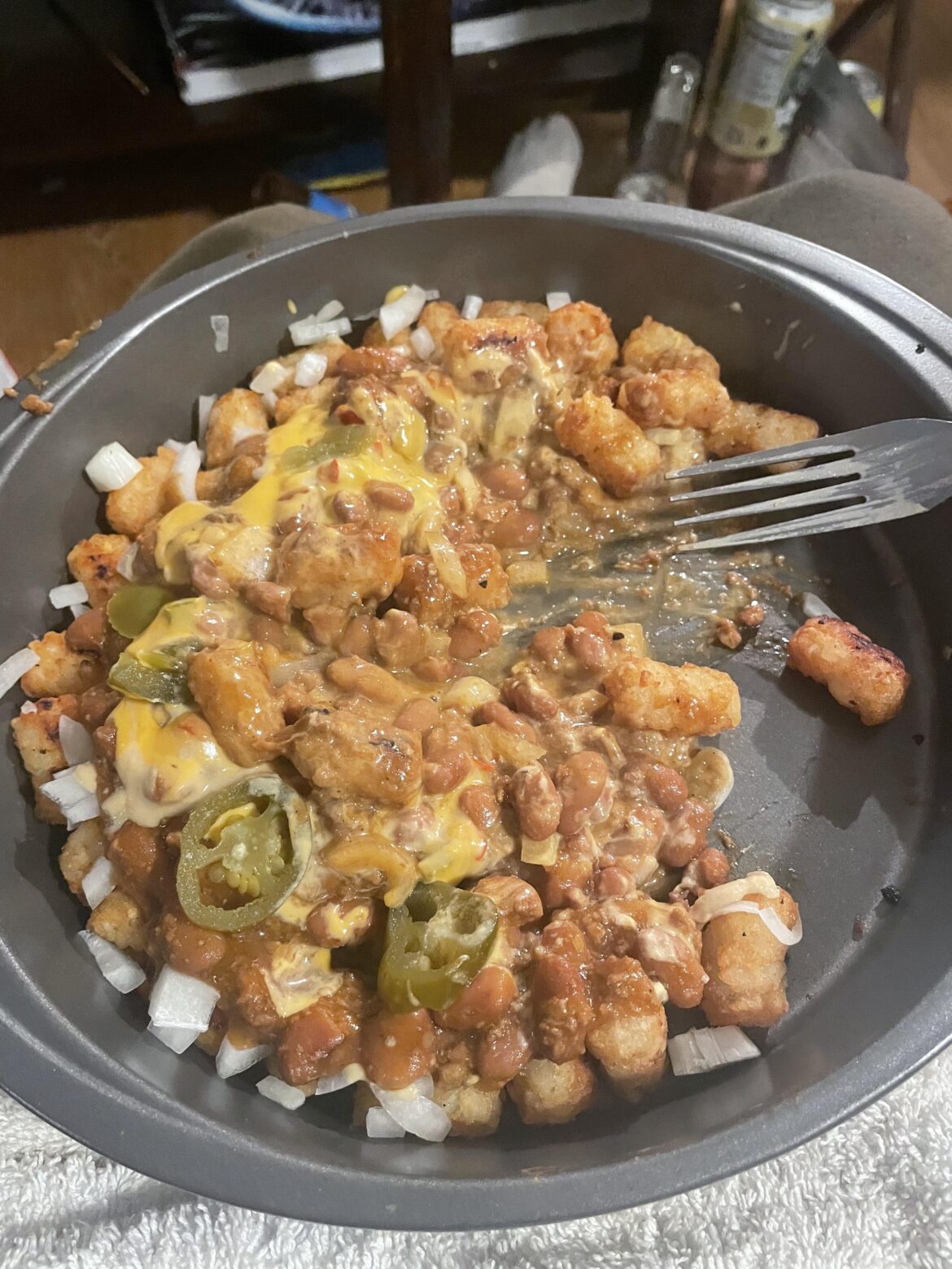 Chili cheese tots w diced onions, jalapeños and