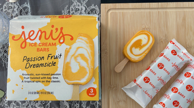 Box of Jeni's Passion Fruit Dreamsicle bars next to unwrapped bar on a cutting board