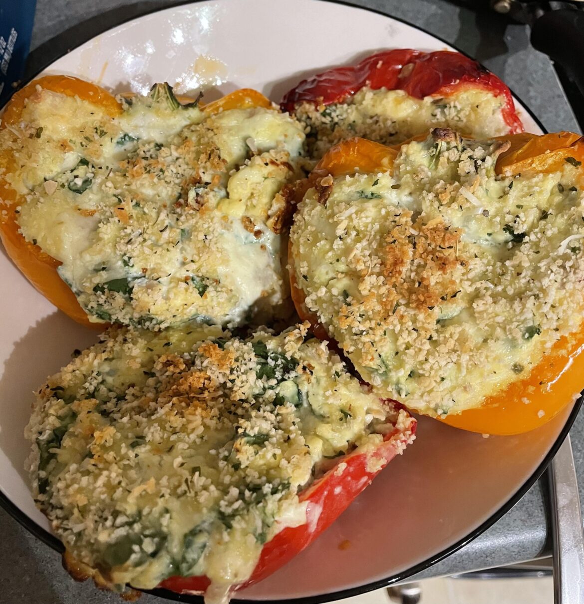 Spinach artichoke (using Greek yogurt) stuffed bell peppers. ~385 calories for two of these (1 pepper cut in half filled with the stuffing). Stuffed!