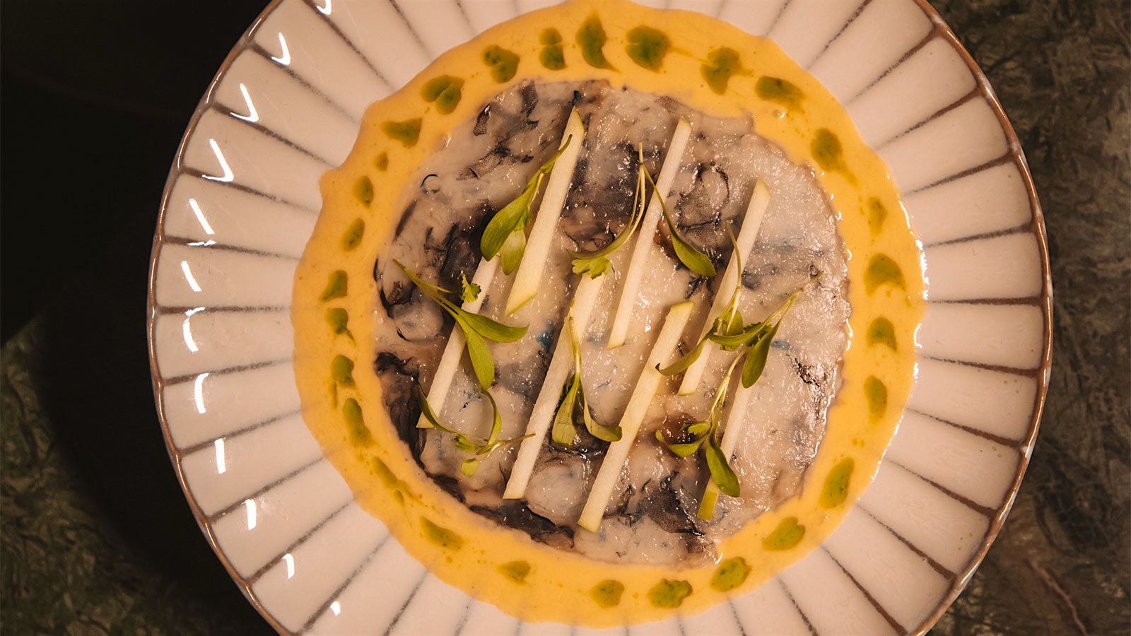  Plate of shrimp carpaccio, dotted with green herb oils