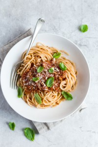 Spaghetti pasta with bolognese sauce and  parmesan cheese, top view
