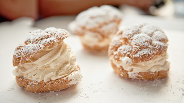 Cream puffs with whipped cream and powdered sugar