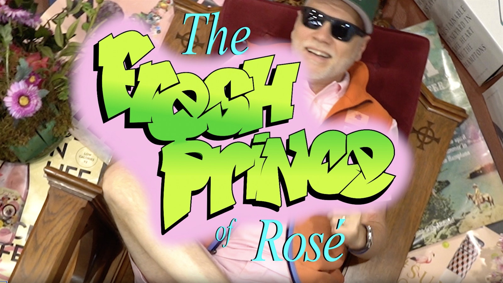  Roman Roth sitting in a chair with sunglasses and a baseball cap, with grafitti lettering reading: "The Fresh Prince of Rosé"