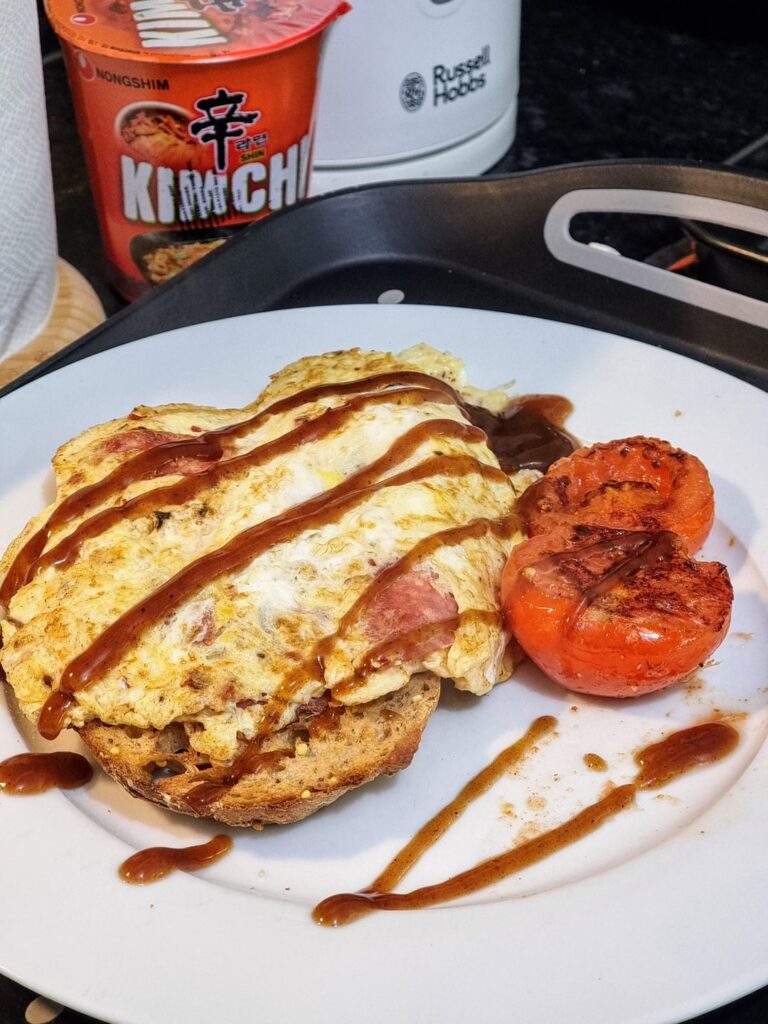 Omelette with Milano Salami on seeded sourdoughbread with a side of fried tomato's.