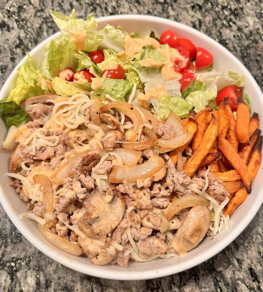 Sriracha mayo burger salad bowl with sweet potato fries