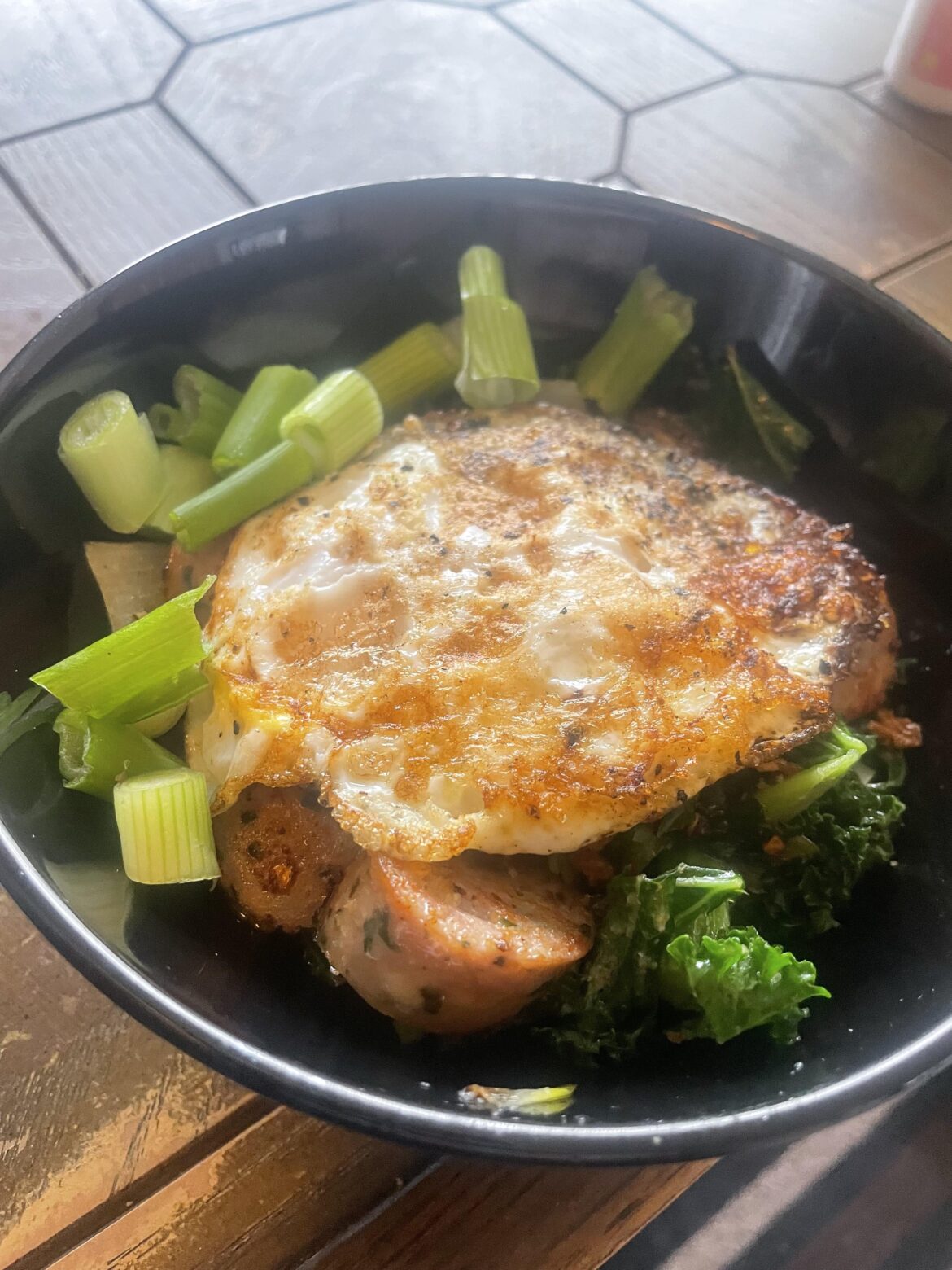 Sautéed kale, chicken sausage, onion, chili oil & fried shallots. Fried egg on top 🫡