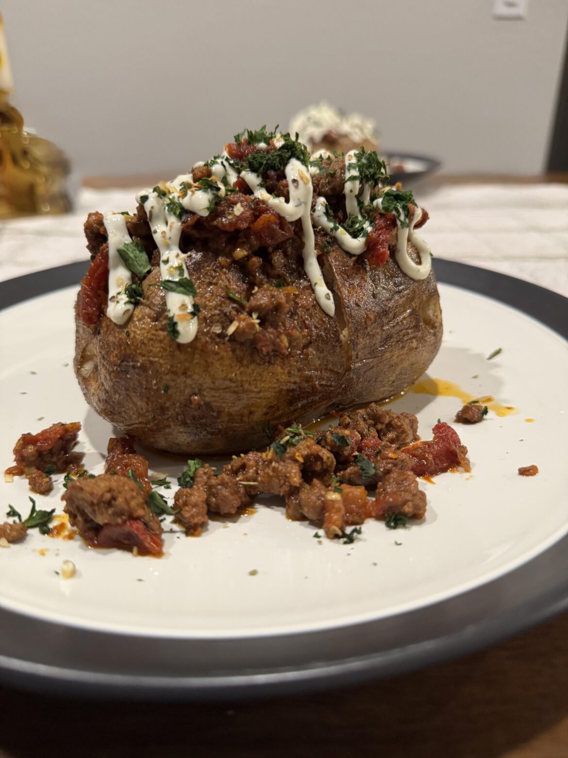 Greek style braised ground lamb on a baked potato
