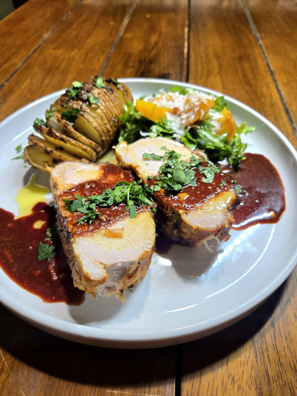 Pork Loin with Hasselback Potato & Red Wine Demi Glace sauce, and an arugula salad with Yellow Beets