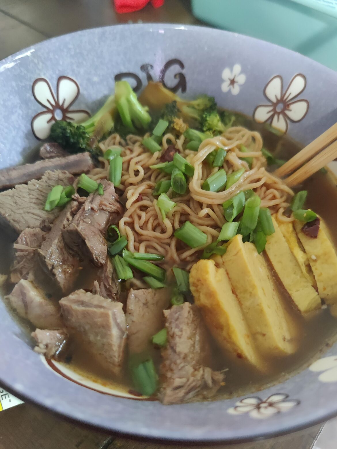 Handmade Ramen Noodles with Beef Bone Broth, Rolled egg omelet, sauteéd Broccoli and Beef Chuck sliced
