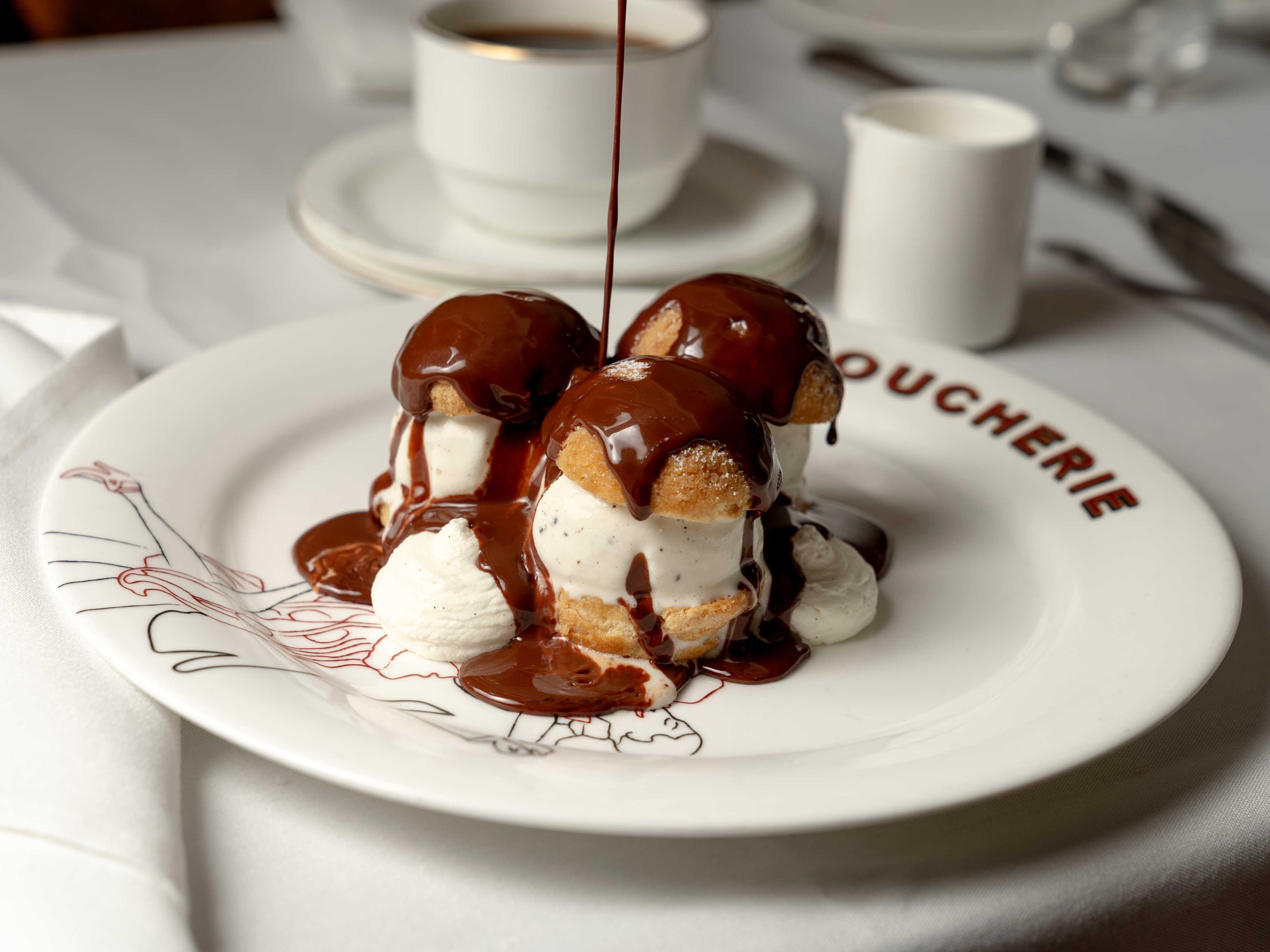 Profiteroles with chocolate sauce drizzled on top.