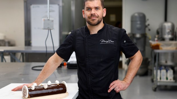 Pastry chef Clément Le Déoré of Desserts by Clement with a bûche de Noël on Tuesday, Nov. 19, 2024. (K.C. Alfred / The San Diego Union-Tribune)